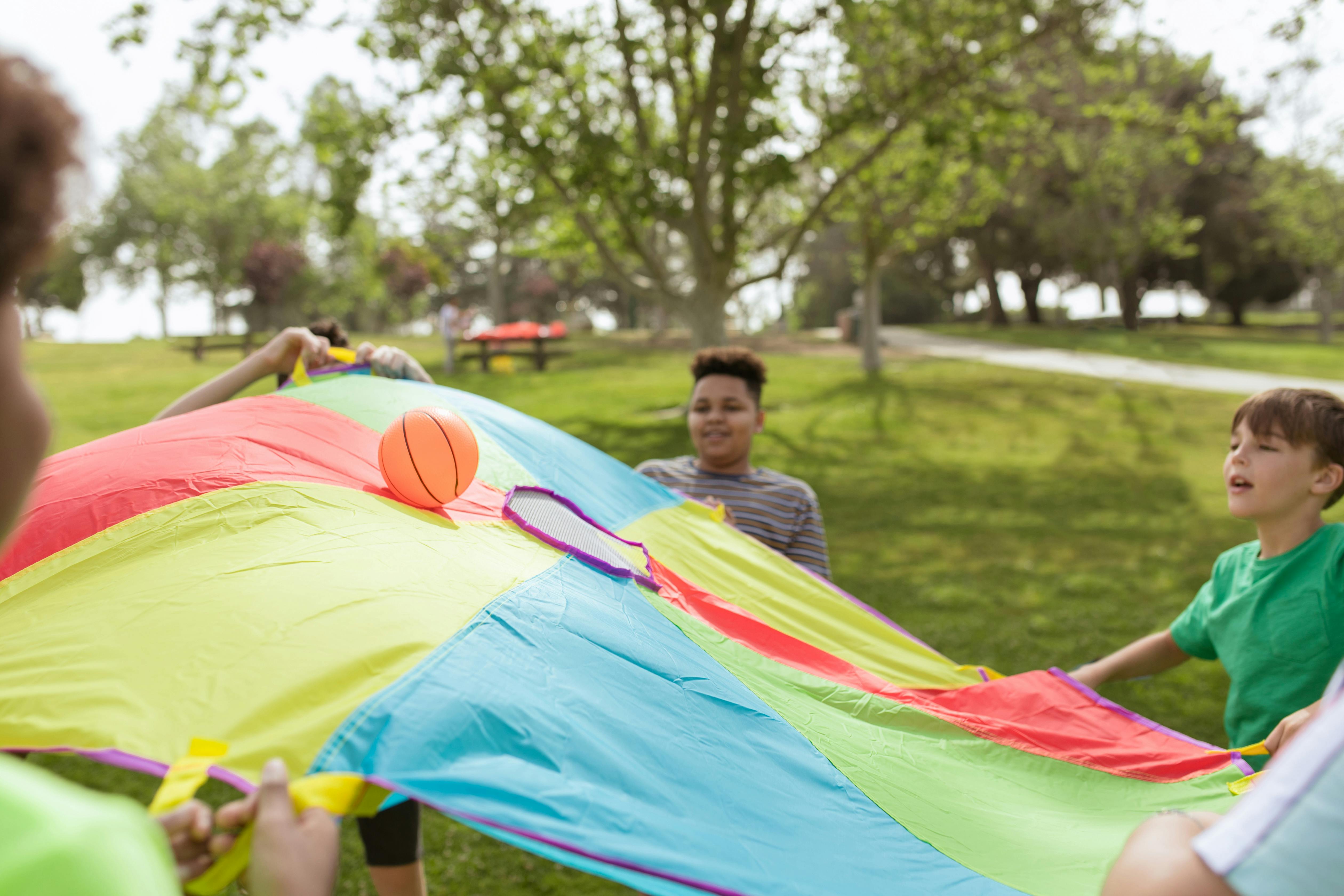 Children playing with a parachute in a Toronto park
